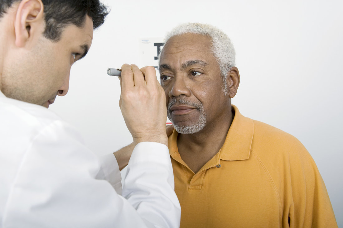 doctor is checking his patient eyes 